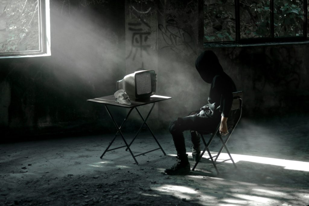 A person looking anxiously at a laptop screen, representing the impact of cyberstalking